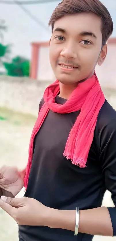 Young person with pink scarf in urban setting.