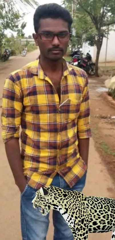 Man in yellow plaid shirt with leopard design on a street.