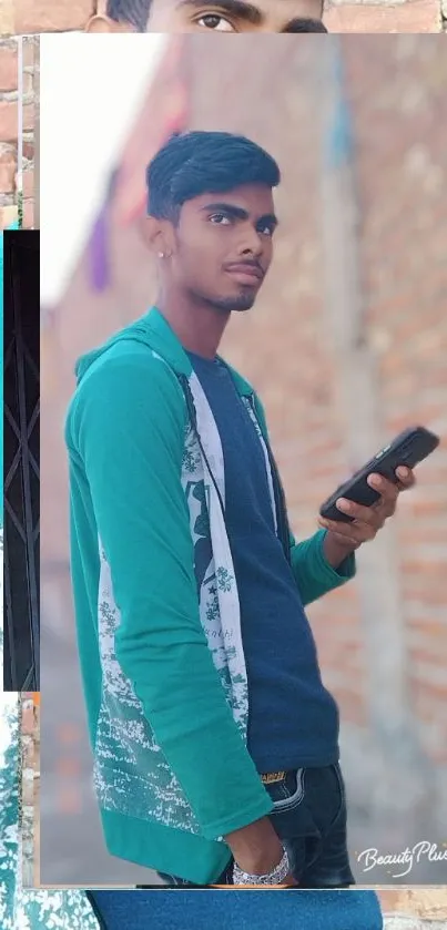 Stylish man in casual attire holding a phone against urban brick wall backdrop.