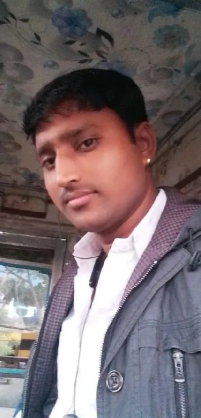 Portrait of a young man with a casual, urban backdrop.