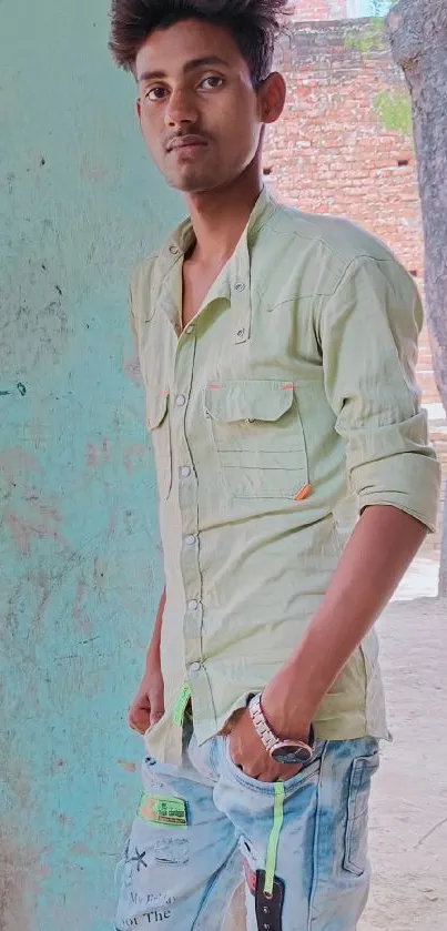 Young person in light green shirt at rustic outdoor setting.