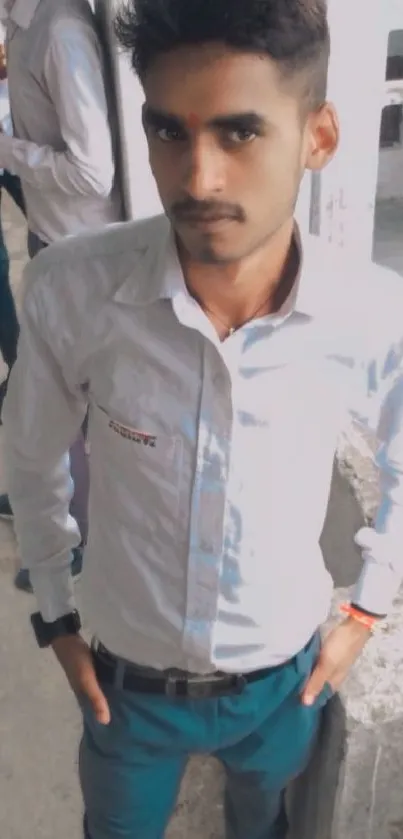 Man in white shirt with casual confidence.