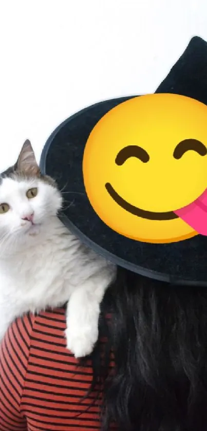 Cat with a hat and smiley emoji face on Halloween.