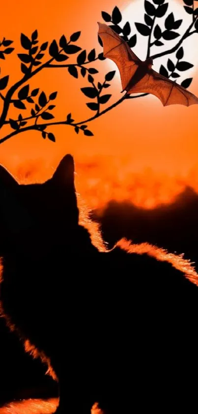 Silhouette of a cat and bat under a tree against an orange sunset.