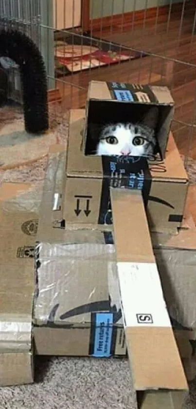 A cat peeking out of a cardboard tank creation.