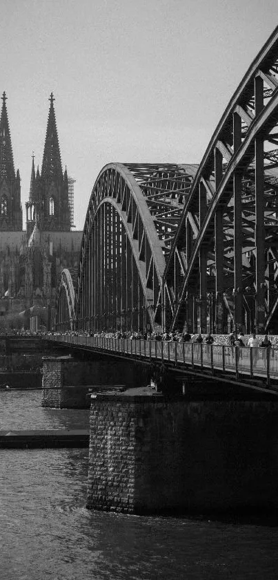 Monochrome view of a cathedral and bridge over river.