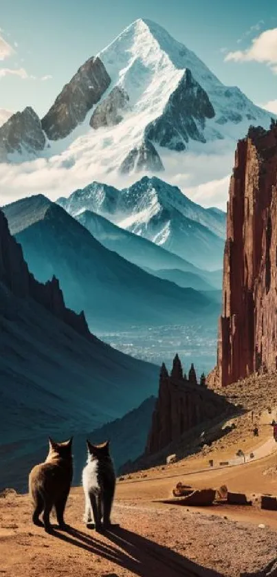 Cats sitting in a valley overlooking majestic snow-capped mountains.