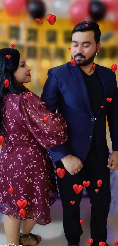 Couple standing with colorful balloons at a celebration event.