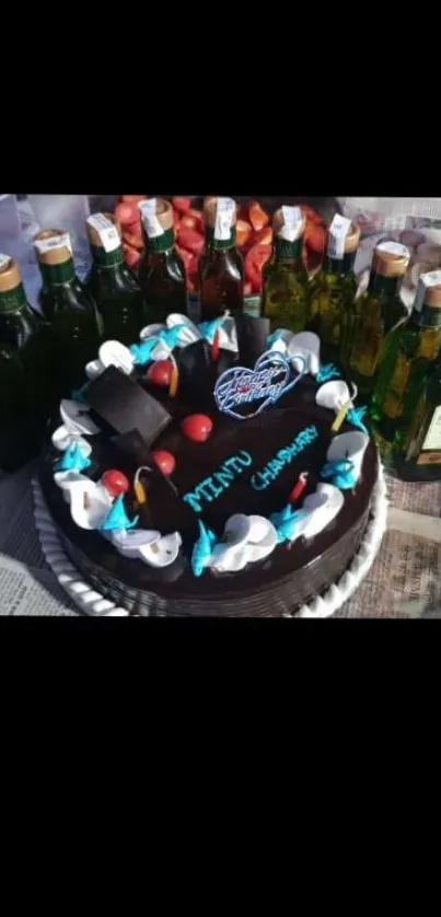 Chocolate cake with candles and olive oil bottles on a festive table.