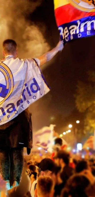 Night celebration with crowd and flags waving.