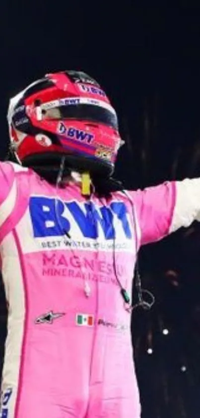 Racing driver in a pink suit celebrating with fireworks.