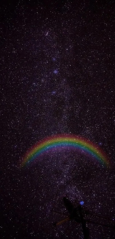 Starry night with a rainbow arc in a dark sky wallpaper.