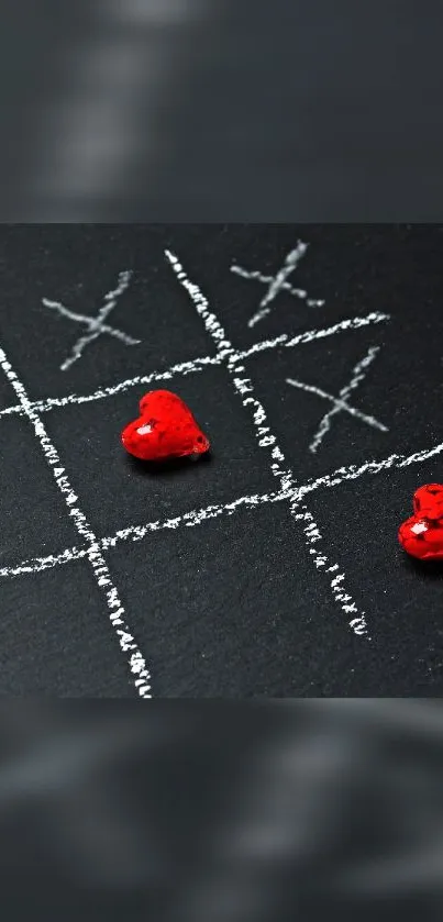 Chalk tic-tac-toe with red hearts on dark background.