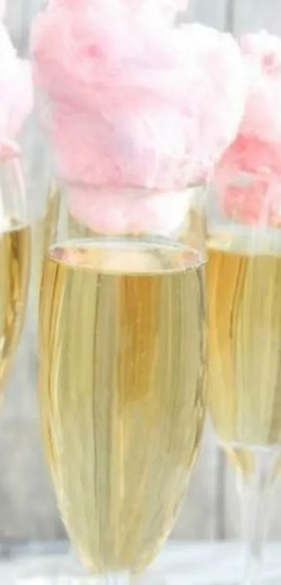 Champagne glasses with pink cotton candy on top.