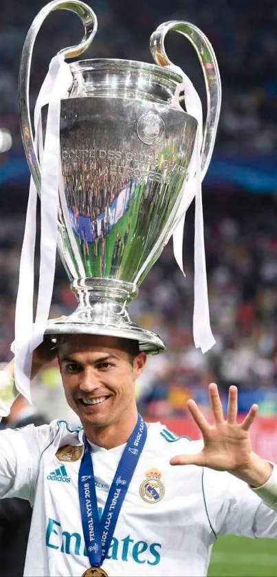 Athlete joyfully holding a large trophy, celebrating victory on the field.