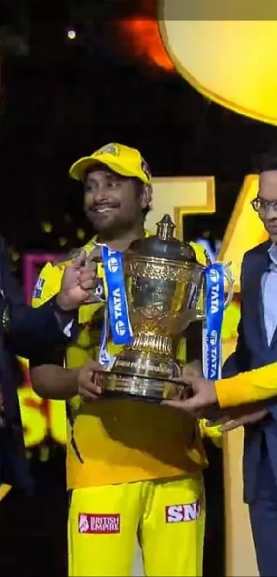 Yellow-clad champions celebrate with trophy on stage.
