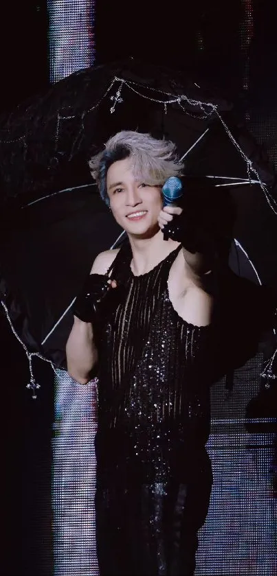 Charismatic performer with a black umbrella on stage.