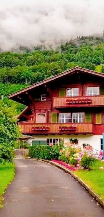 Alpine chalet surrounded by lush greenery and foggy hills.