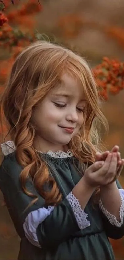 Red-haired child in autumn setting with leaves.