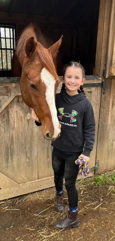 Girl smiling with horse in rustic barn setting.