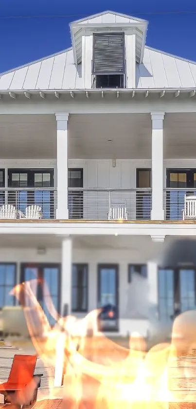 Cozy beachfront house with fire pit and blue sky background.