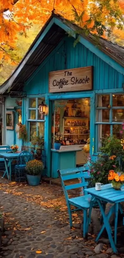 Quaint blue coffee shack surrounded by autumn leaves.