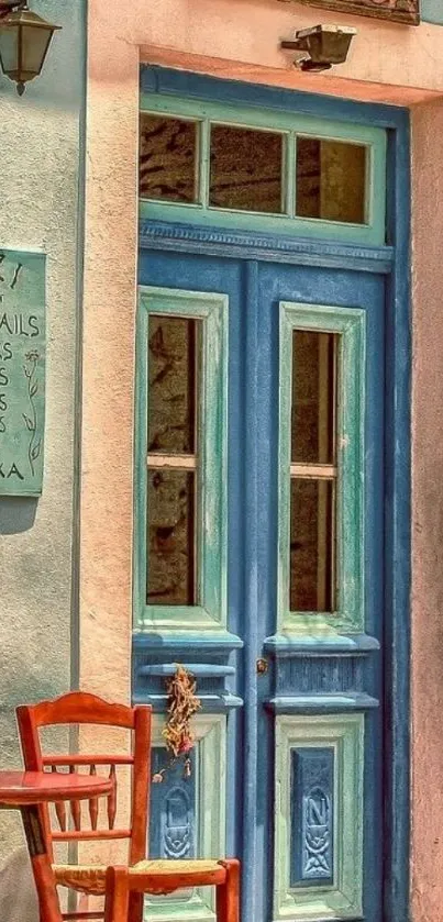 Blue door and wooden chair at a quaint cafe entrance.