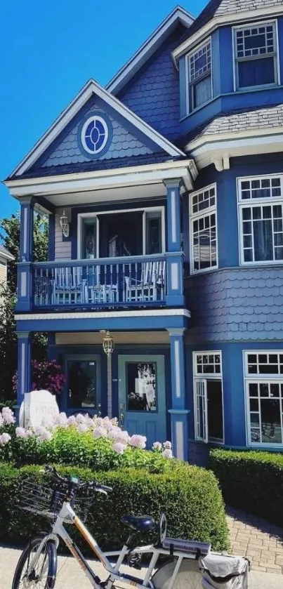 Charming blue Victorian house with bicycle in front.