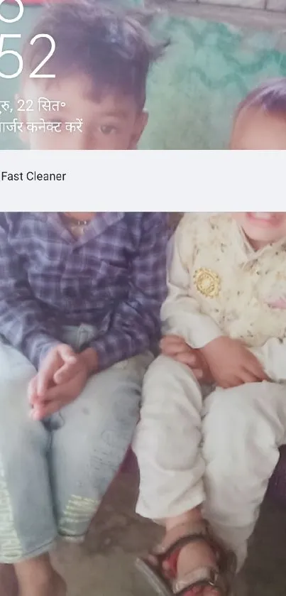 Photo of two young brothers sitting indoors on a bench.