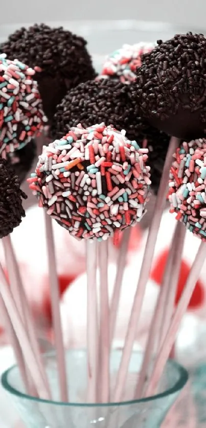 Charming cake pops in a glass bowl with chocolate and pastel colors.