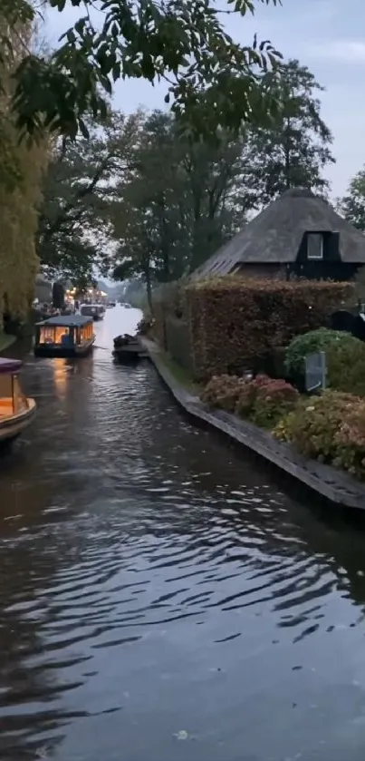 Peaceful canal scene with boats and cottages at dusk.