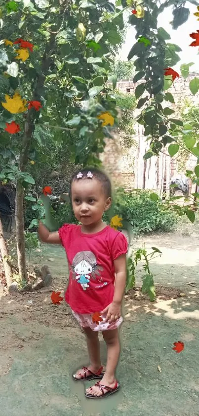 Adorable child in red shirt with autumn leaves in a lush garden.