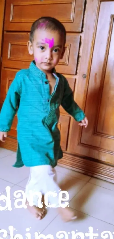 Adorable child in traditional Indian attire with a festive background.