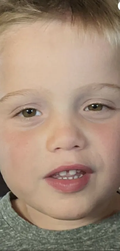 Close-up portrait of a smiling child with bright eyes.