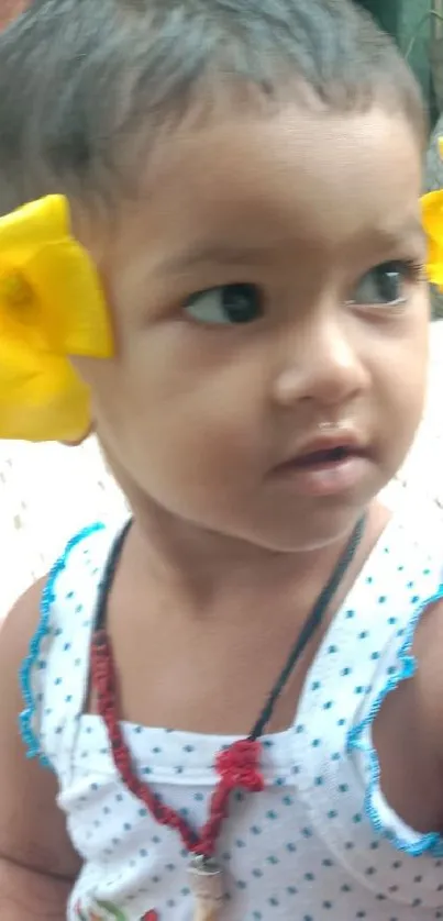 Cute child with yellow flowers in her hair.