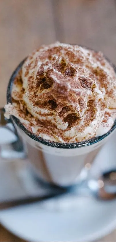 Coffee mug with whipped cream on a wooden table.
