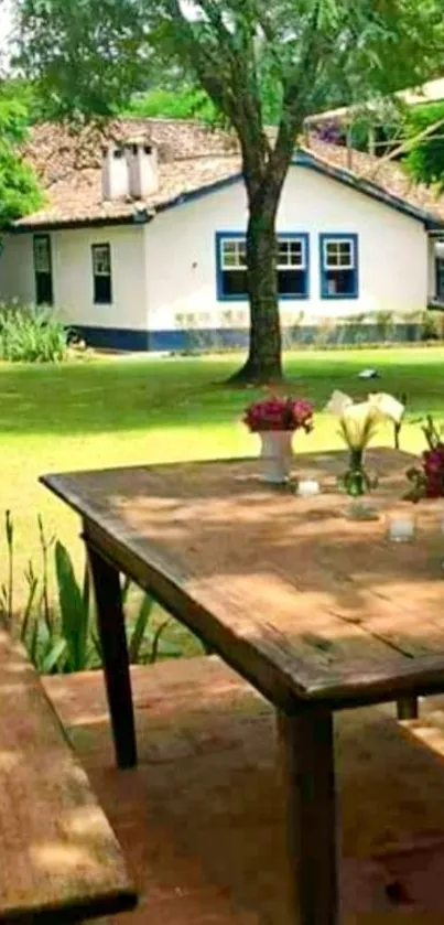 Rustic cottage garden view with wooden table and lush greenery.