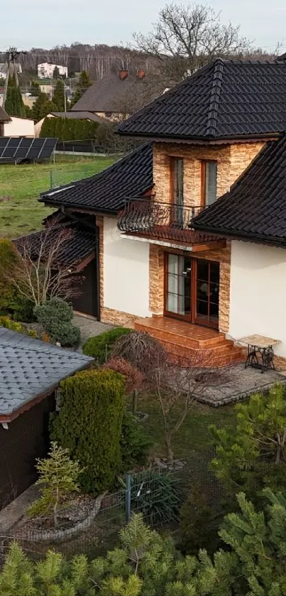 A charming countryside cottage with a dark slate gray roof surrounded by greenery.