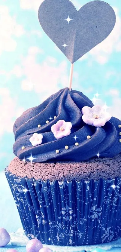 Blue cupcake with heart topper and flowers.