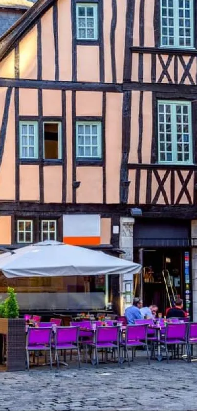 Charming European street with cafes and historic timbered buildings.