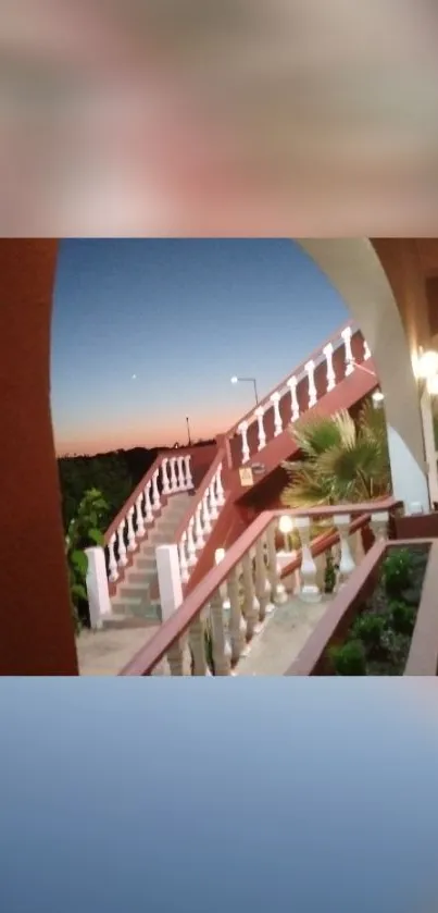 Evening balcony view with soft blue sky and architectural details.