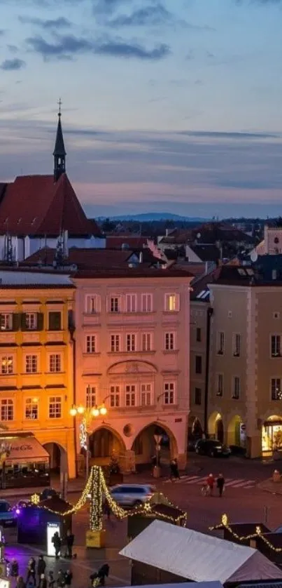 Twilight view of a charming European town square with festive lights.