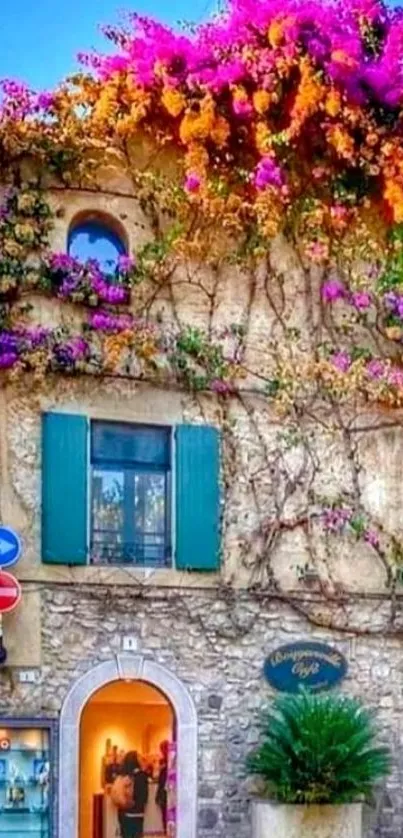 Rustic house with vibrant purple flowers cascading over the stone walls.