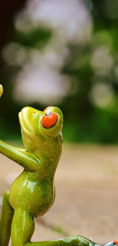 Green frog figurine holding a flower, set on a natural background.