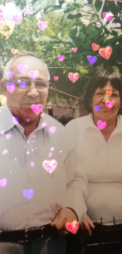 Elderly couple in garden setting with greenery.