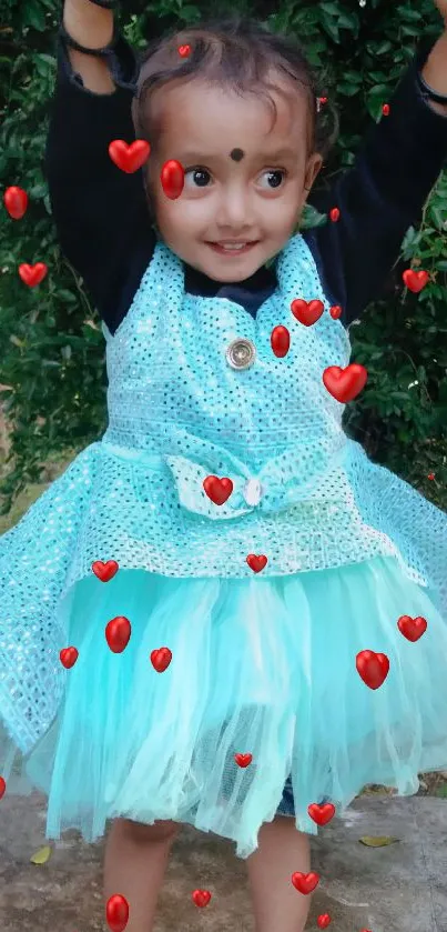 Child in blue dress posing outdoors, full of joy, on a mobile wallpaper.