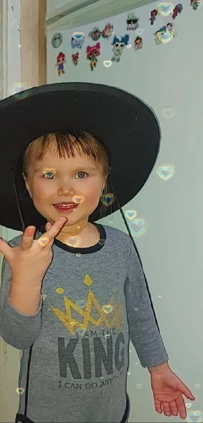 Child with a hat and glowing hearts decor.