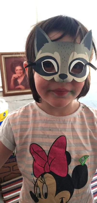 Child wearing a fox mask with colorful background.