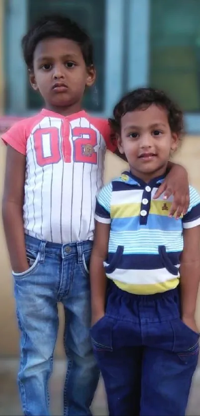 Two kids standing together in casual attire.