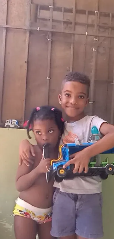 Two kids playing in a cozy home setting with toys and smiles.